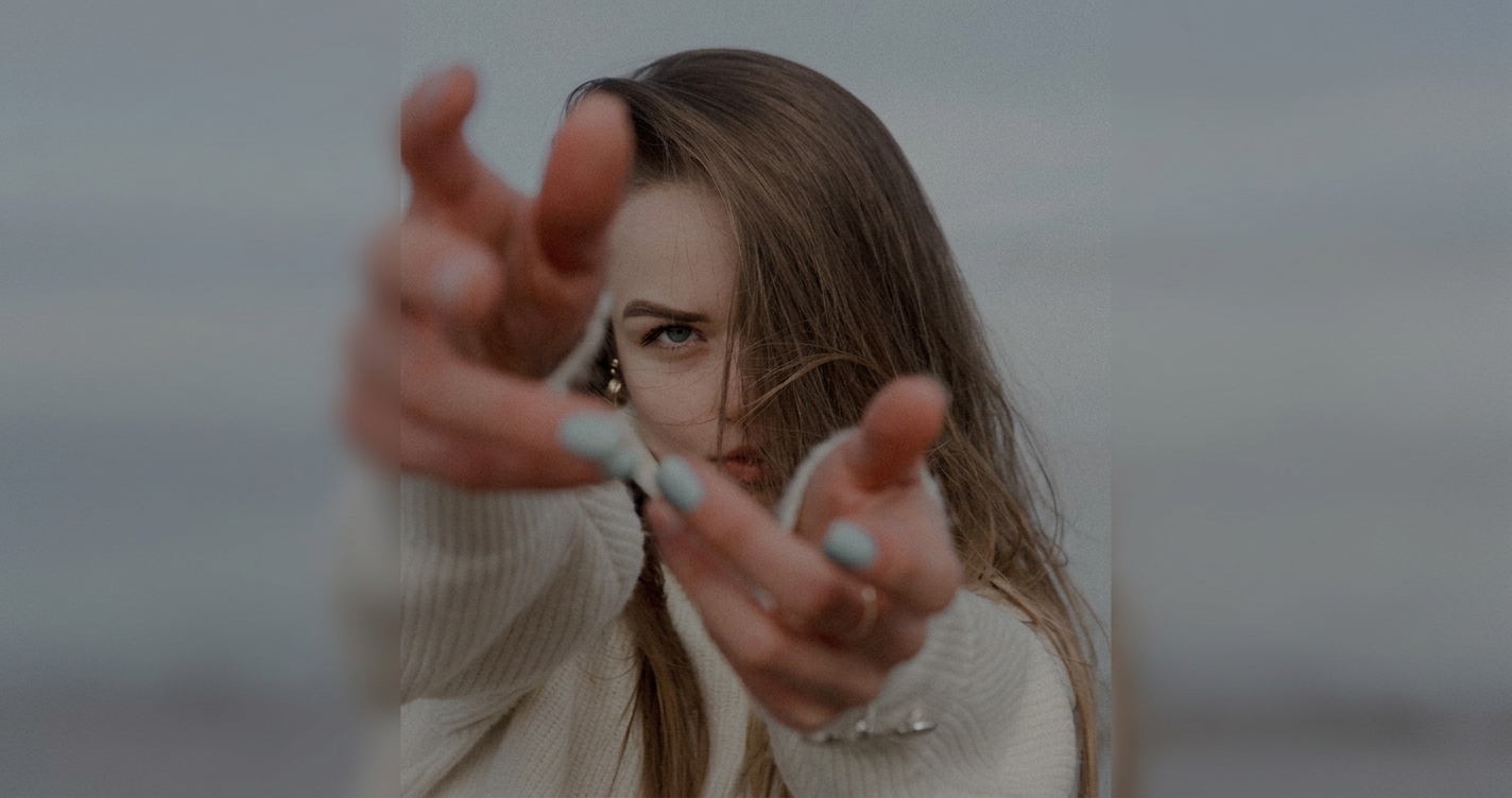 Girl extending hand toward camera representing confident response to being called fake